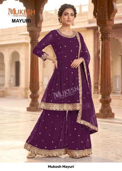 Mukesh Mayuri: A deep purple sharara salwar suit with gold zari embroidery on the kurta border, sleeves, and hem.