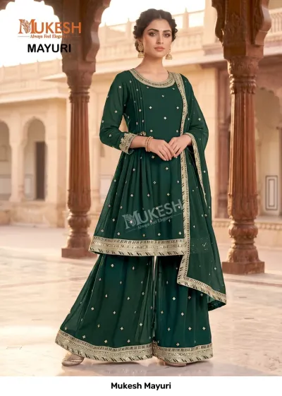 Mukesh Mayuri: A dark green sharara salwar suit decorated with subtle gold zari motifs and intricate metallic border work.