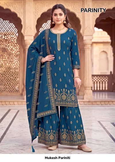 Mukesh Pariniti peacock blue salwar suit with a printed kurta, sharara, and dupatta featuring gold zari detailing and motifs.