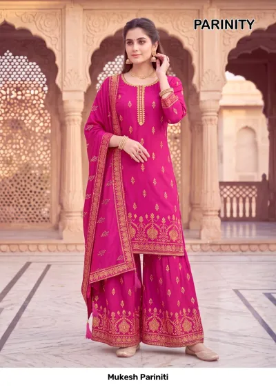 Mukesh Pariniti magenta pink salwar suit featuring a short kurta with sharara pants, gold printed patterns, and gold zari embroidery.