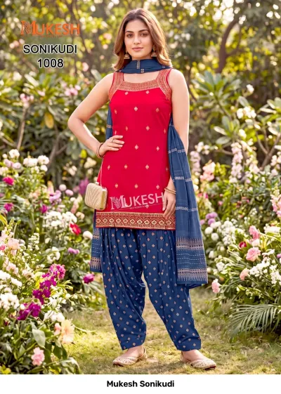 Mukesh Sonikudi 1008, red sleeveless kurti with gold embroidery, paired with a blue printed salwar and matching dupatta.
