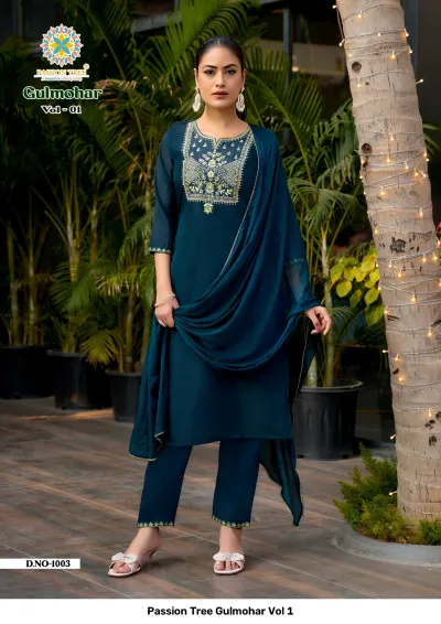 Passion Tree Gulmohar Vol 1: Dark teal salwar suit with geometric thread work embroidery on the neckline, matching pants, and a matching dupatta.