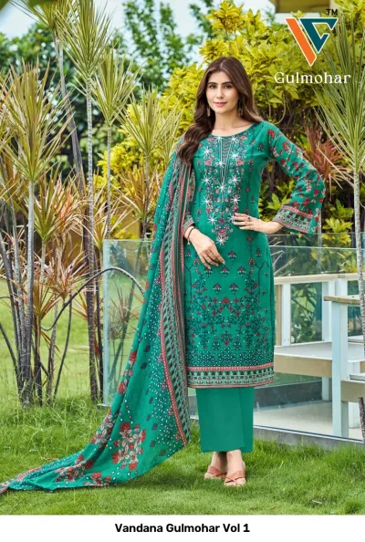 Vandana Gulmohar Vol 1 emerald green printed salwar suit featuring floral designs and white thread embroidery, paired with a matching patterned dupatta.