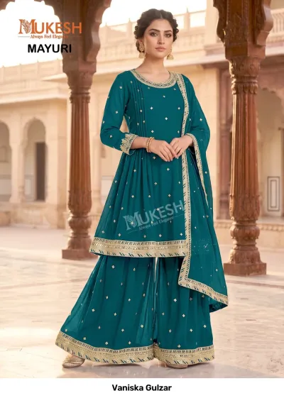 Vaniska Gulzar: Teal blue sharara salwar suit with delicate gold sequin embellishments and zari work on the hemline.
