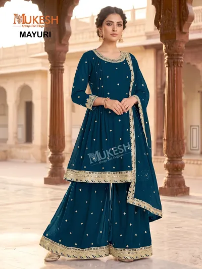 Vaniska Gulzar: Dark teal blue sharara salwar suit with gold sequin motifs and elaborate zari work on the hem.