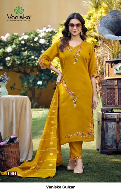 Vaniska Gulzar: Mustard yellow salwar suit with floral embroidery, featuring a straight-cut kurti, trousers, and striped zari dupatta.