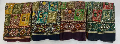 Wholesale Ajrak Print Mirror Work Sarees: Multi-colored printed sarees with geometric patterns and mirror work embellishments.