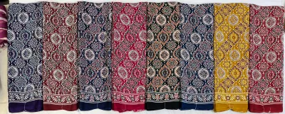 Wholesale Ajrak Printed Crepe Sarees: Six folded sarees in multicolored Ajrak print with floral block patterns.