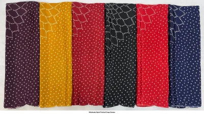 Wholesale Ajrak Printed Crepe Sarees: Six folded sarees in different colors with small white polka-dot Ajrak patterns.