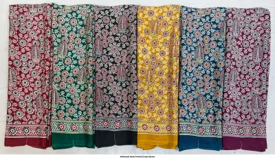 Wholesale Ajrak Printed Crepe Sarees: Five folded sarees in assorted colors with repeating leaf Ajrak block prints.