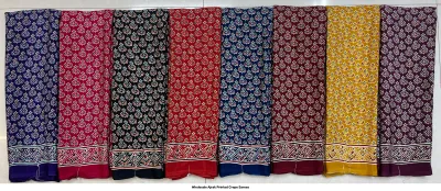 Wholesale Ajrak Printed Crepe Sarees: Seven folded sarees in multiple colors with repeating leaf Ajrak block prints.