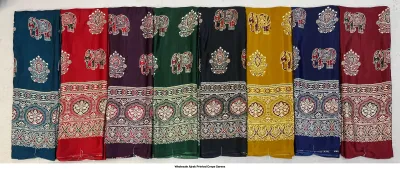 Wholesale Ajrak Printed Crepe Sarees: Seven sarees in varying colors with elephant and floral Ajrak block prints.