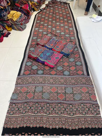 Wholesale Ajrak Printed Crepe Sarees: Single saree in black with a printed border and floral Ajrak pattern.