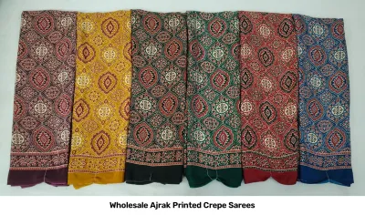 Wholesale Ajrak Printed Crepe Sarees: Catalog layout displaying a black saree with elephant and circular Ajrak prints and folded textile samples.