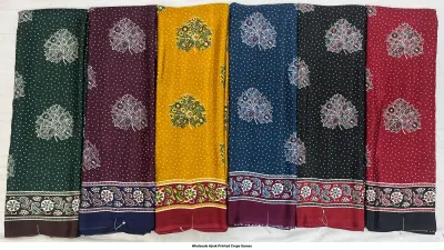 Wholesale Ajrak Printed Crepe Sarees: Five folded sarees in distinct colors with repeating circular Ajrak print motifs.