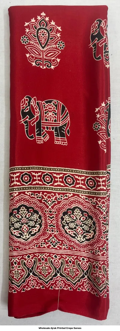 Wholesale Ajrak Printed Crepe Sarees: Catalog layout showing a white saree with large circular and small elephant Ajrak prints with fabric samples.
