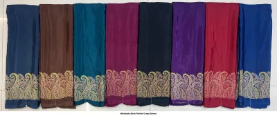 Wholesale Ajrak Printed Crepe Sarees: Catalog layout showcasing a black saree with floral and geometric Ajrak prints and fabric swatches.