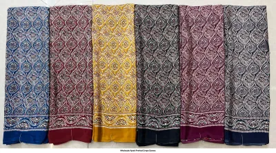 Wholesale Ajrak Printed Crepe Sarees: Six colorful folded sarees with repeated circular floral Ajrak block print patterns.