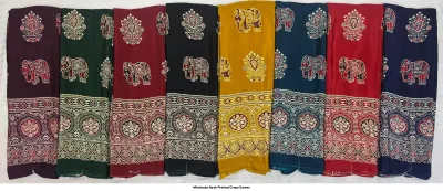 Wholesale Ajrak Printed Crepe Sarees: Six folded sarees with elephant motifs and intricate Ajrak border prints.