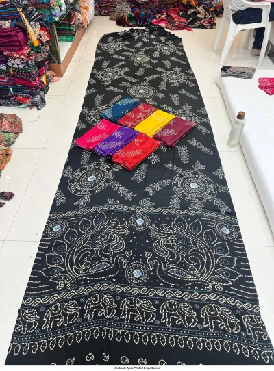 Wholesale Ajrak Printed Crepe Sarees: Six colorful folded sarees featuring repeating circular Ajrak prints.