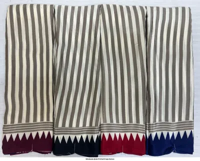 Wholesale Ajrak Printed Crepe Sarees: Seven colorful folded sarees with intricate floral and geometric Ajrak patterns.