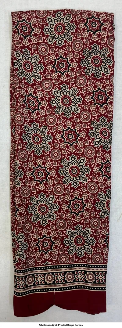Wholesale Ajrak Printed Crepe Sarees: Single saree with deep red base and repeating circular floral Ajrak print.