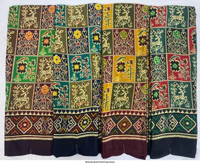 Wholesale Ajrak Printed Crepe Sarees: Six folded sarees with repeating geometric Ajrak patterns in various vibrant colors.