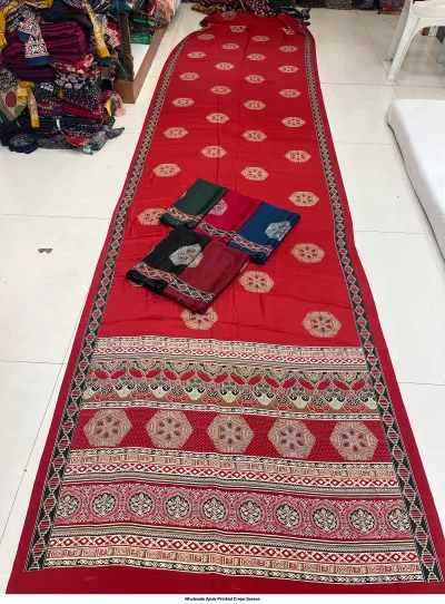 Wholesale Ajrak Printed Crepe Sarees: Single saree in deep red with repetitive elephant and circular Ajrak block prints.
