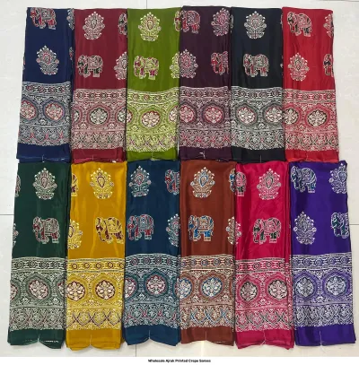 Wholesale Ajrak Printed Crepe Sarees: Seven folded sarees in assorted colors with matching leaf Ajrak block print motifs.