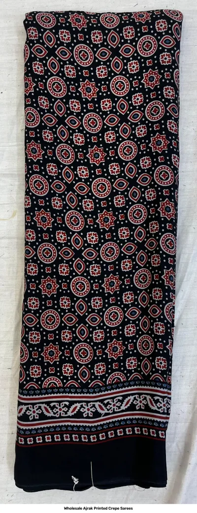 Wholesale Ajrak Printed Crepe Sarees: Single saree with black base and repeating small geometric Ajrak print.