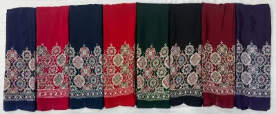 Wholesale Ajrak Printed Crepe Sarees: Seven folded sarees in various colors with uniform floral Ajrak print designs.