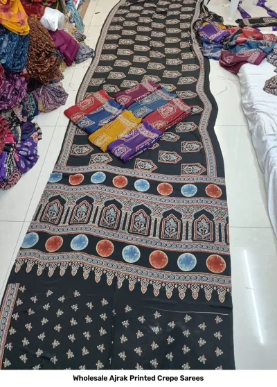 Wholesale Ajrak Printed Crepe Sarees: Catalog layout featuring black Ajrak printed saree with circular motifs and folded fabric options.