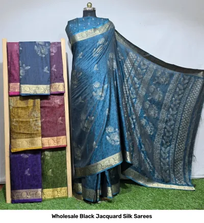 Wholesale Black Jacquard Silk Sarees: Teal floral print saree with gold zari border, displayed on mannequin with assorted color variations on rack.