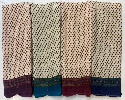 Wholesale Crepe Silk saree, repeated small leaf motif on cream base with varied colored borders.