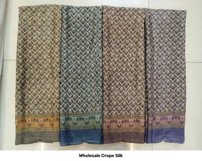 Wholesale Crepe Silk saree, repeating leaf motif print in earth tones with decorative border.