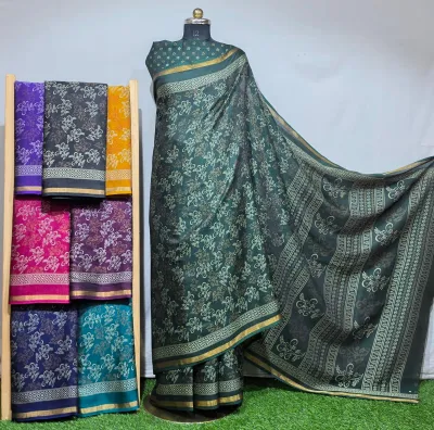Wholesale Discharge Print Black Pearl Cotton Sarees: A dark green cotton saree with white floral discharge prints and a thin gold zari border.