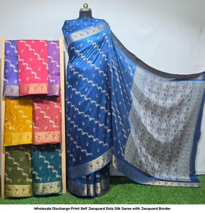 Wholesale Discharge Print Self Jacquard Dola Silk Saree with Jacquard Border: Blue saree, small floral discharge print, self-jacquard pattern, gold zari-work border.