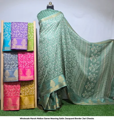 Wholesale Marsh Mellow Saree Weaving Satin Jacquard Border Jari Checks light green satin saree with floral thread work and matching folded sarees on rack.