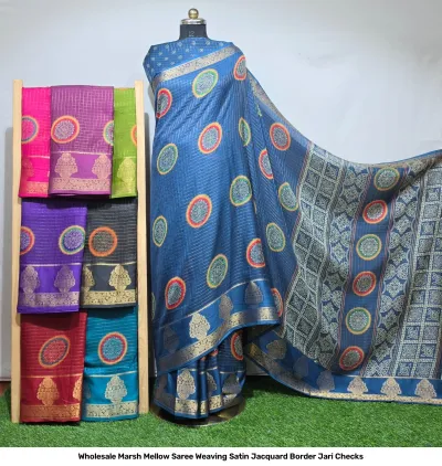 Wholesale Marsh Mellow Saree Weaving Satin Jacquard Border Jari Checks blue satin saree with circular motifs and zari border with folded sarees on rack.