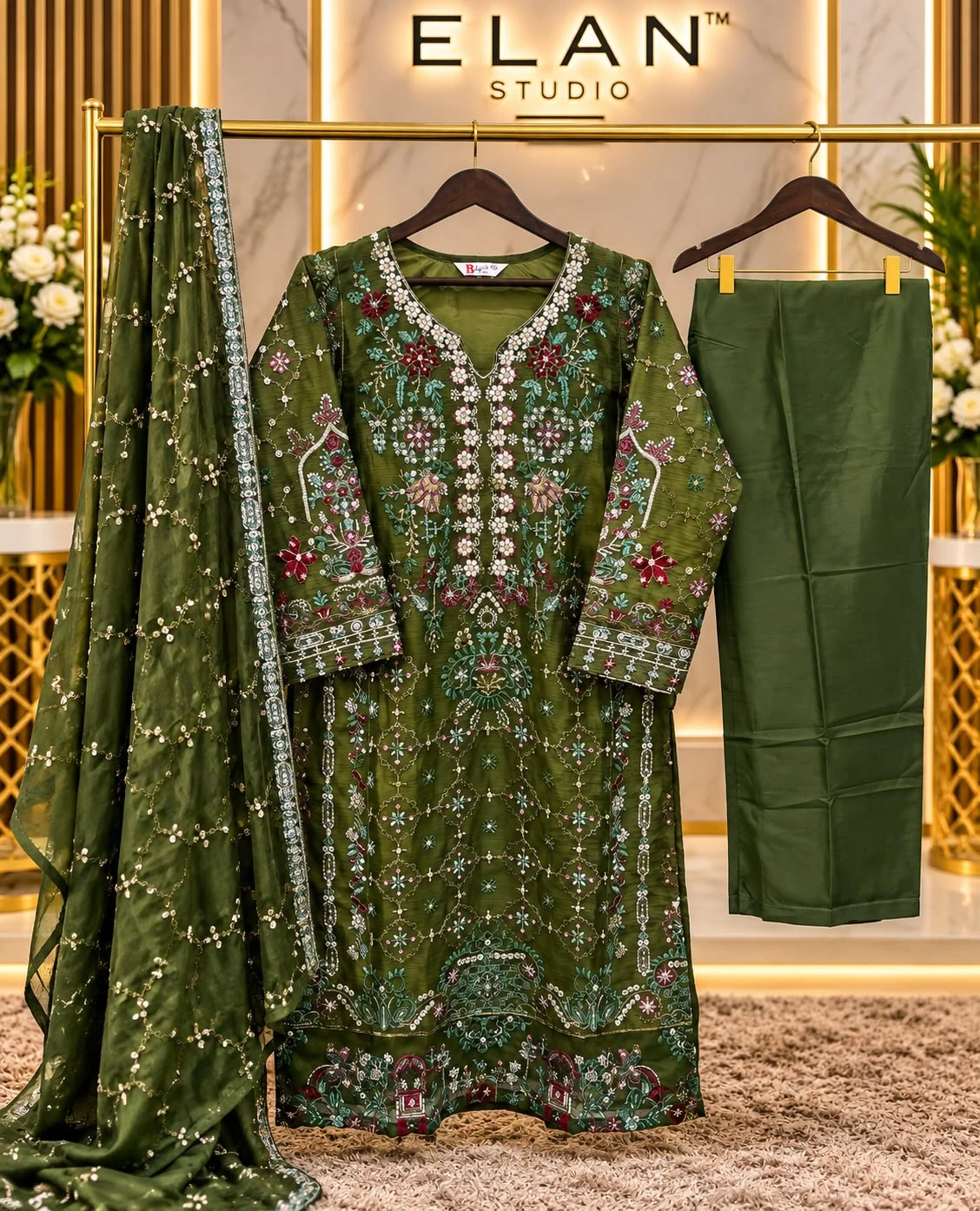Zulfat Kohinoor: Dark olive green salwar suit set with intricate floral thread and sequin embellishment, paired with a matching dupatta and trousers.
